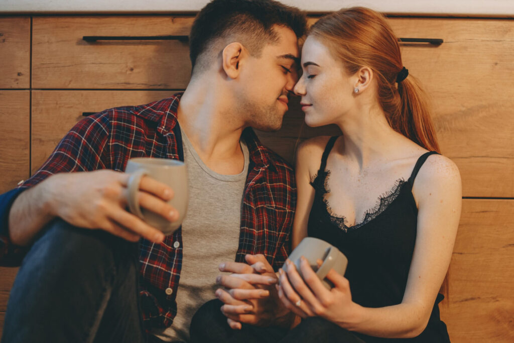 how to flirt: a man and woman holding cups
