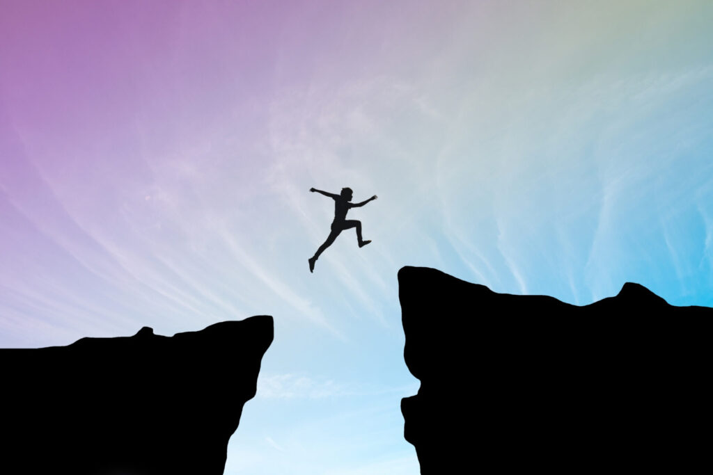 a person jumping over a cliff