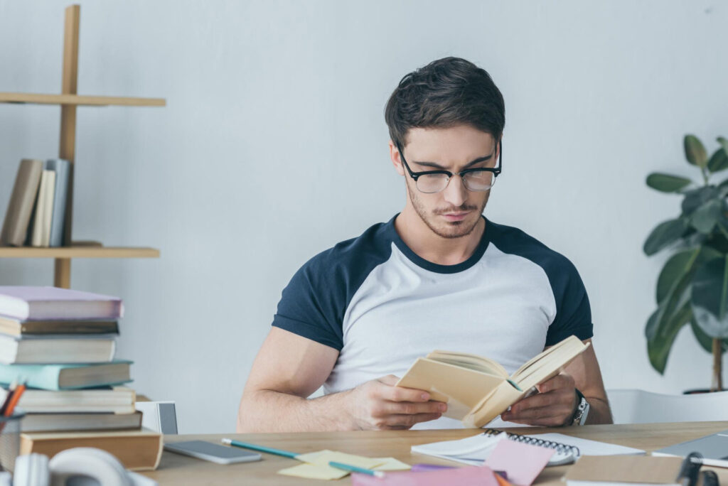 a man reading a book - study tips for exams without stress