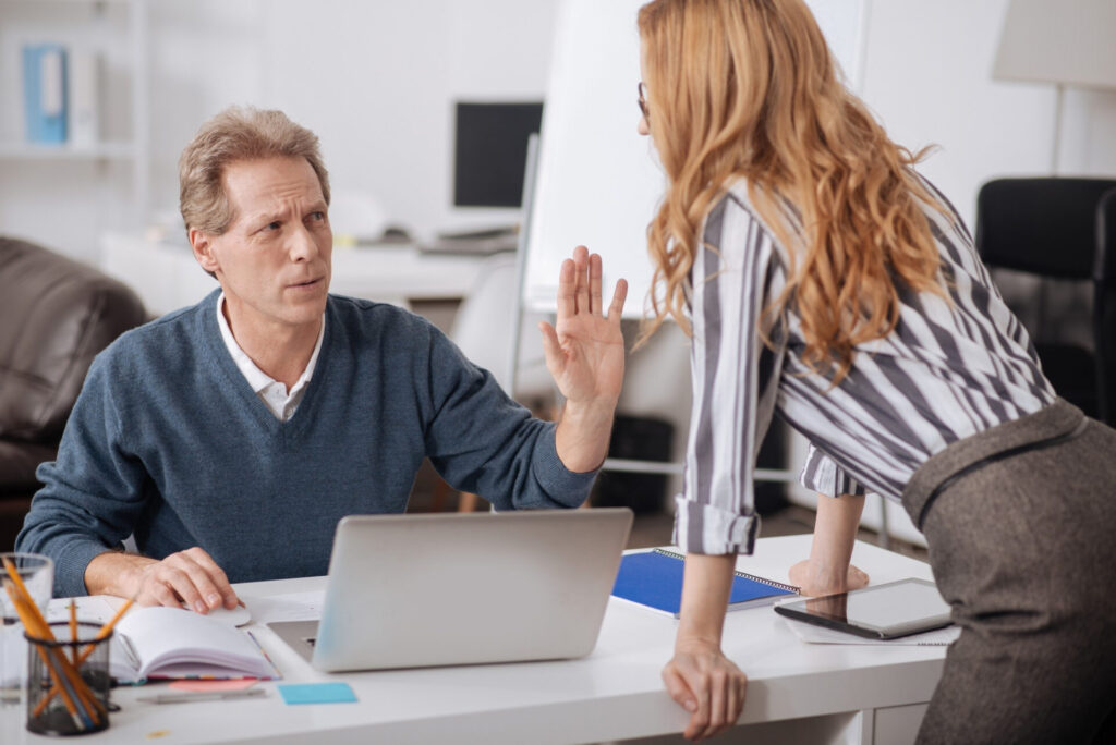 a man and woman standing at a desk
