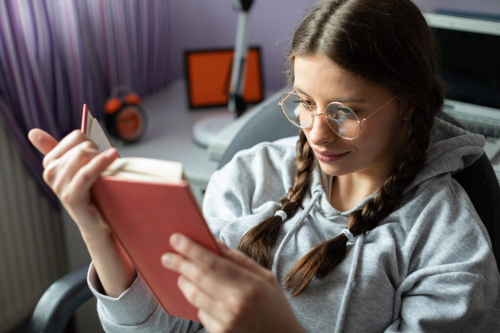 a woman reading a book - how to study effectively for exams