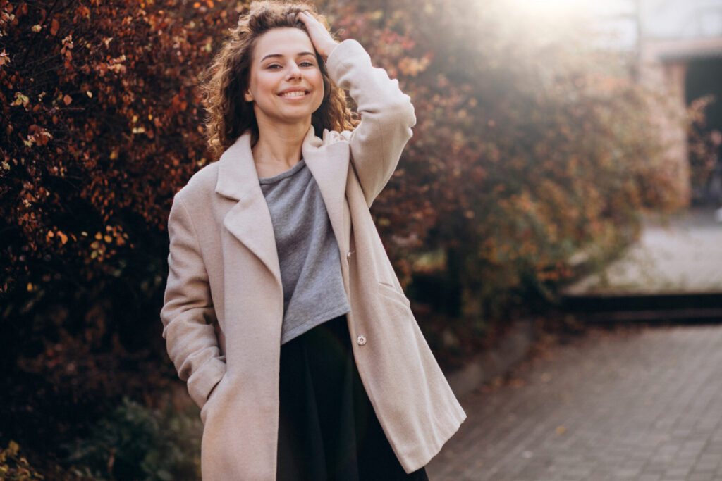 a woman smiling with her hand in her hair - stop doubting yourself