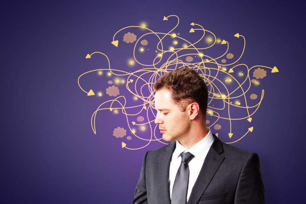 a man in a suit and tie looking down at arrows - change your mindset and change your life