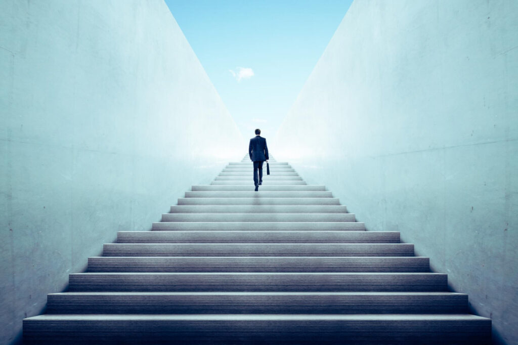 a man walking up a staircase - life transformation journey