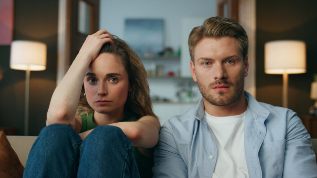 how to stop fighting in a relationship: a man and woman sitting on a couch