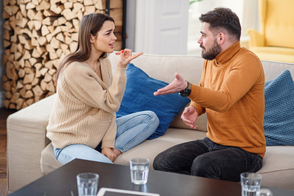 how to set personal boundaries: a man and woman sitting on a couch