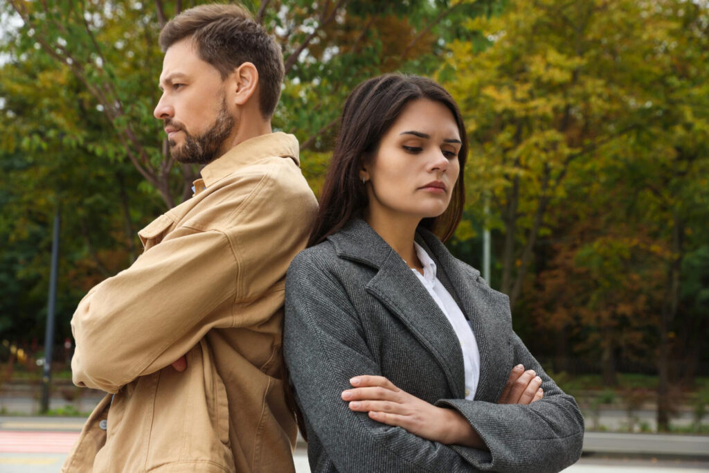 set boundaries without feeling guilty: a man and woman standing back to back