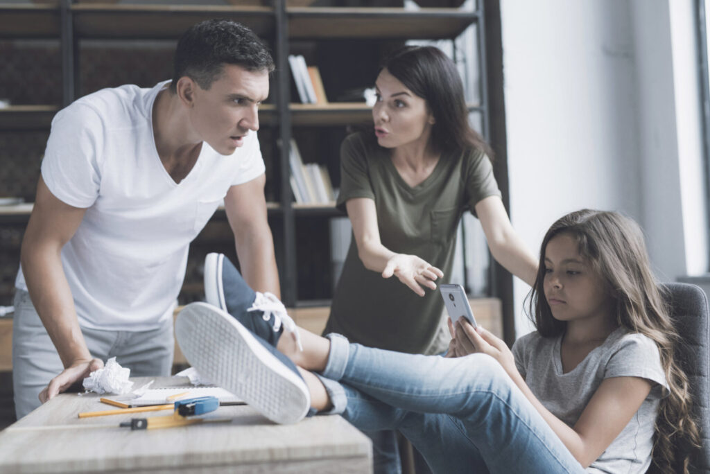 how to discipline a child effectively: a man and woman looking at a phone