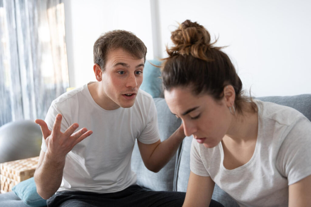 Sibling rivalry resolution: a man and woman sitting on a couch