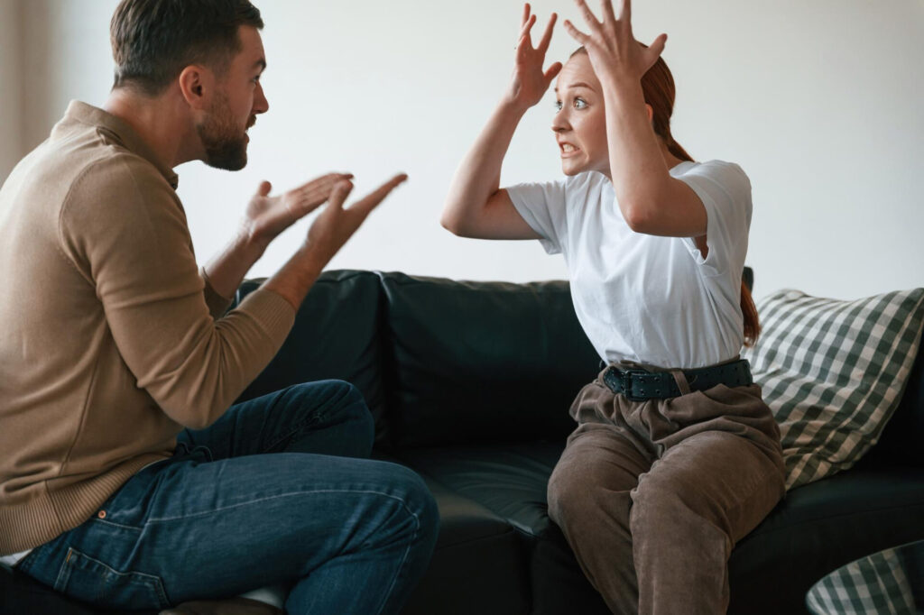 a man and woman sitting on a couch