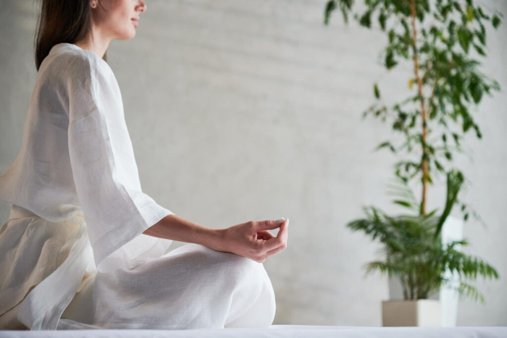 a woman meditating in a room