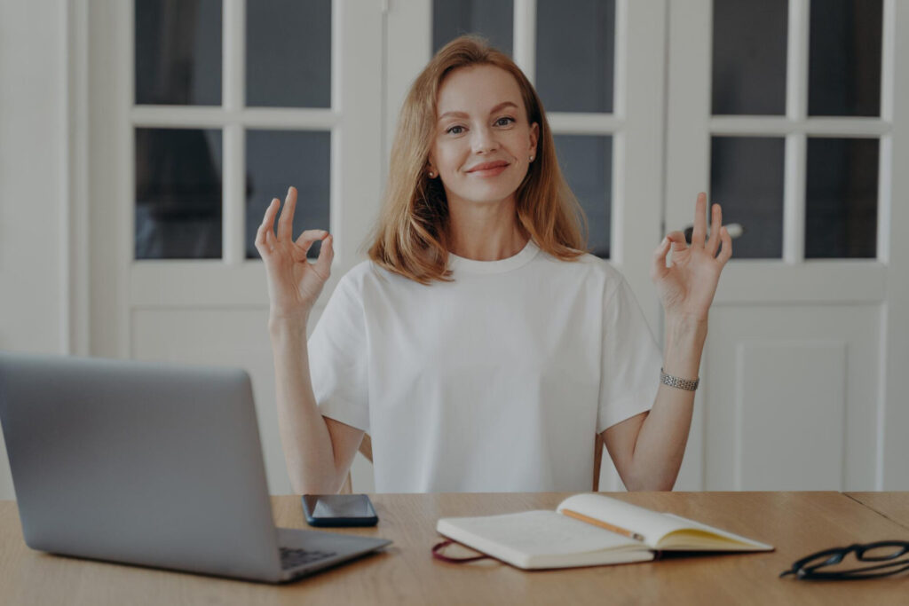 Decision Making & Focus - a woman sitting at a table with her hands up - emotional intelligence decision making