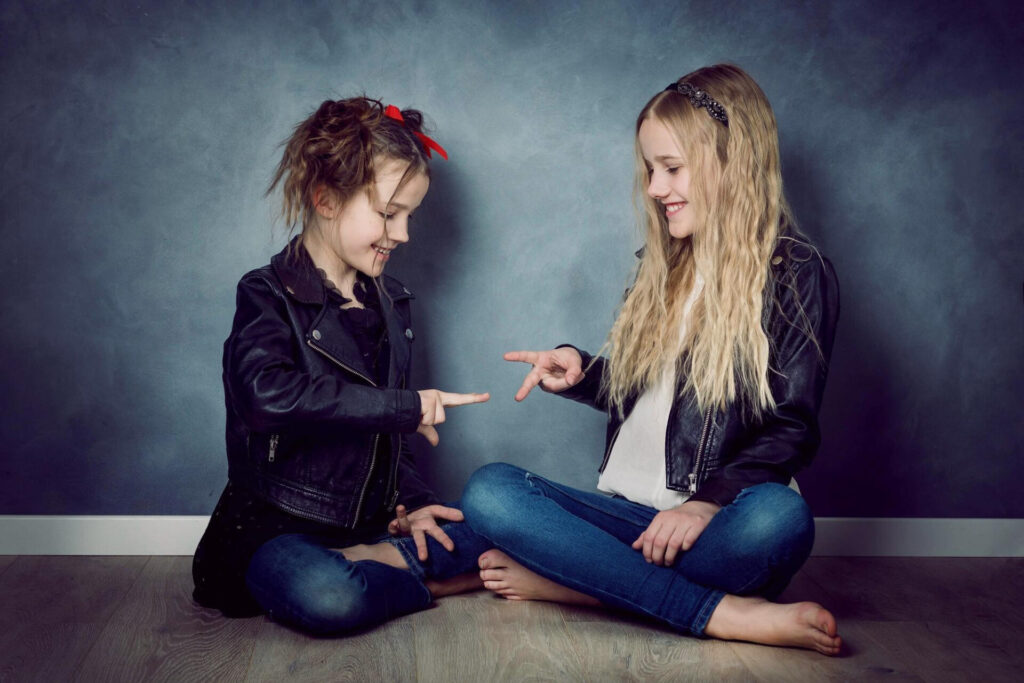 two girls sitting on the floor