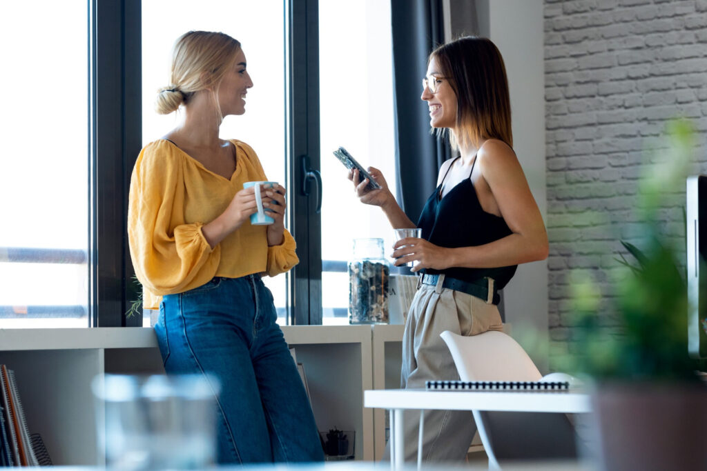 How Mirroring Enhances Sales Success: two women holding cups and talking