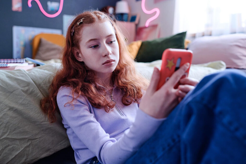 a girl looking at a phone