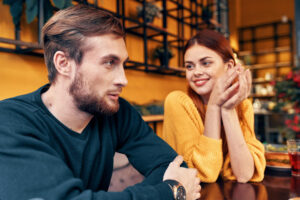 How to Build Rapport Quickly and Naturally: a man and woman sitting at a table