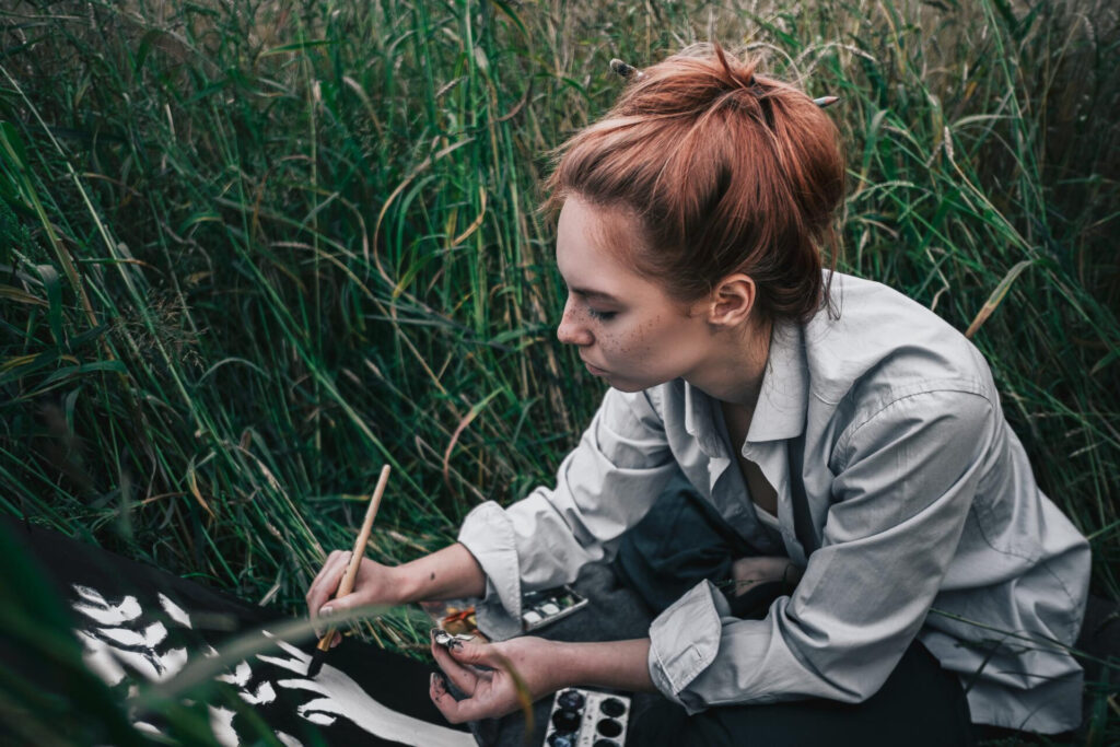 female artist painting in nature 
 - embrace curiosity like a child