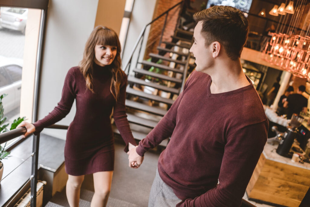 how to set emotional boundaries: a man and woman holding hands and walking down stairs