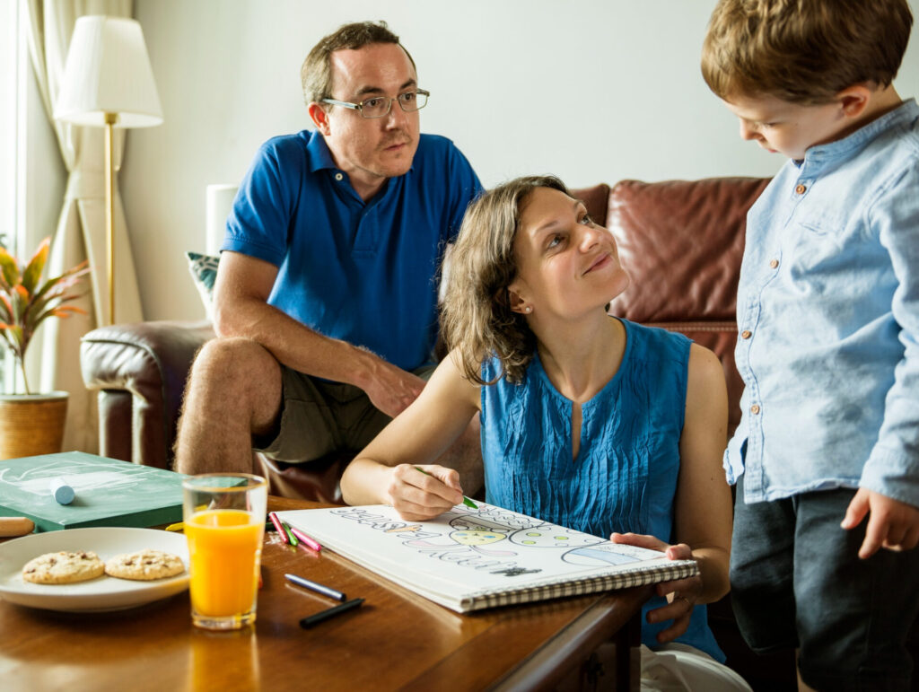 a man and woman drawing on a book: parenting differences between generations
