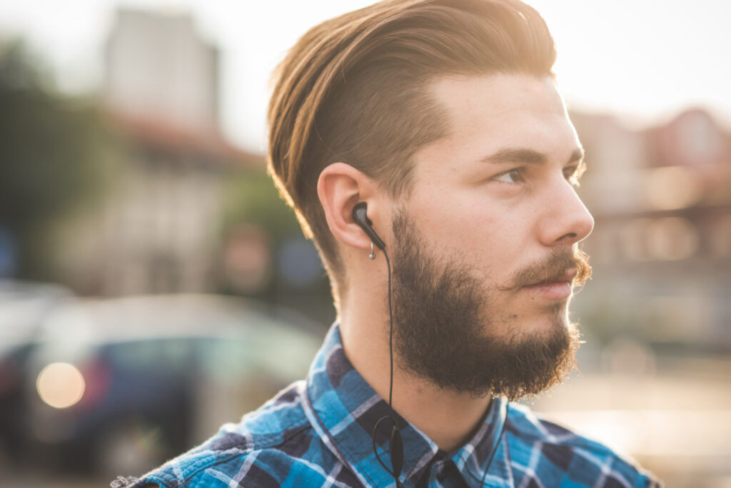 a man with a beard wearing earphones