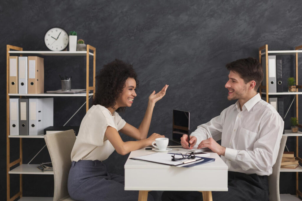 a man and woman sitting at a desk