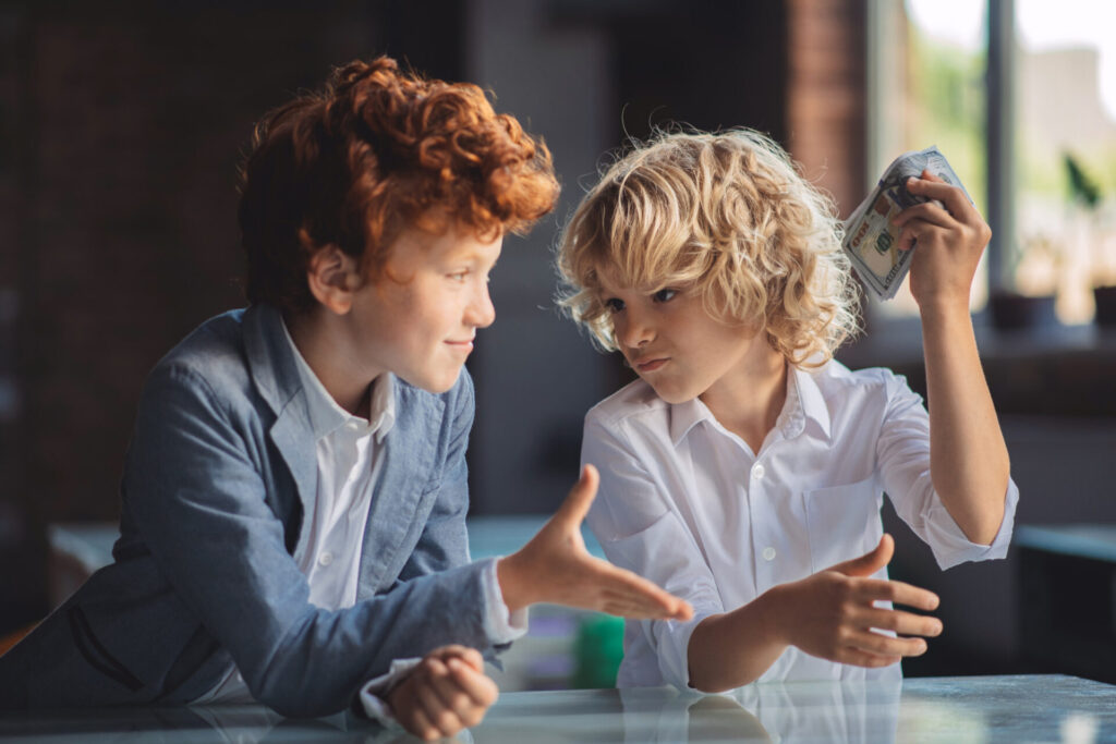 a boy and girl sitting at a table