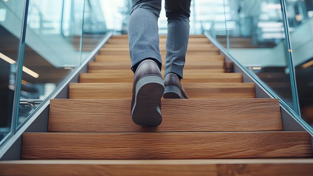 a man walks up the stairs - how to achieve big goals with small steps
